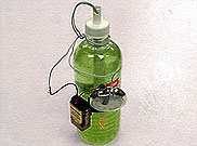 image of plastice bottle with green sustance inside with wires coming out