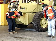 photo of two workers coughing and rubbing their eyes