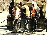 NYSDOT operations employees repairing a road