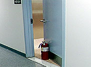 image of suspicious canister used to prop open a door