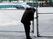 image of man breaking into fence
