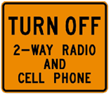 Road sign reading Turn Off 2-way radio and cell phone